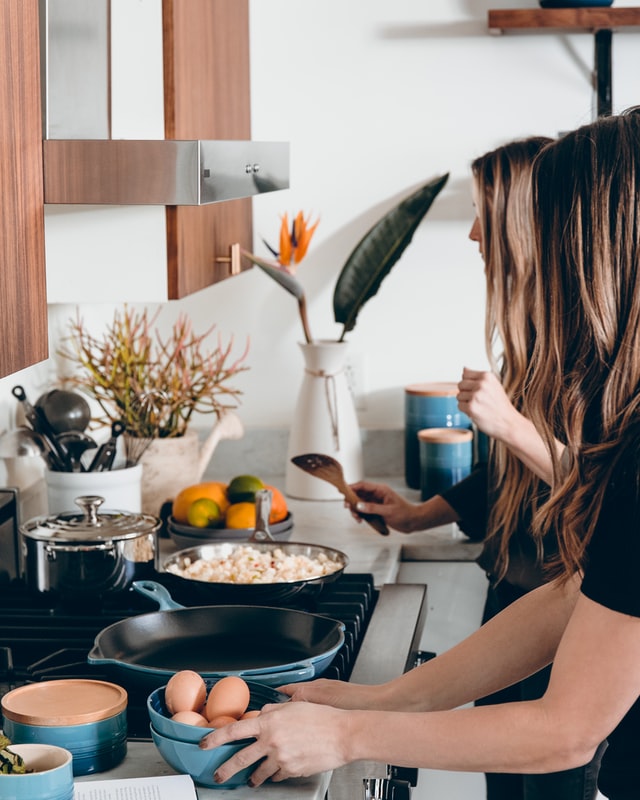 women cooking protein